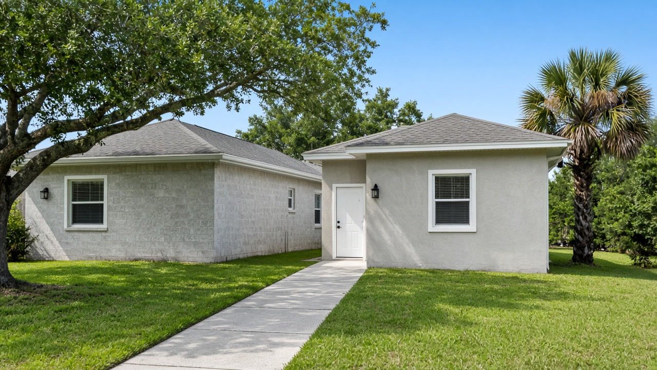 A single-story Florida house with a new one-room addition on its side